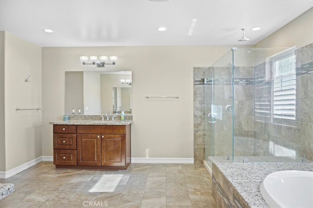 14012 Quailridge Drive Riverside, CA 92503 - Photo 34 of 44 a spacious bathroom with a granite countertop sink a toilet and shower