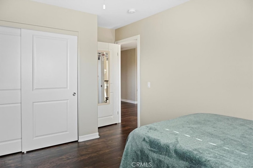 14012 Quailridge Drive Riverside, CA 92503 - Photo 36 of 44 a bedroom with a bed and wooden floor