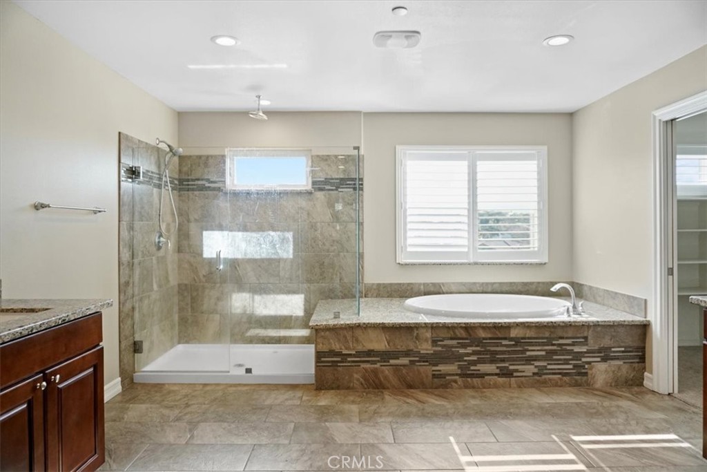 14012 Quailridge Drive Riverside, CA 92503 - Photo 41 of 44 a bathroom with a tub a sink and a shower