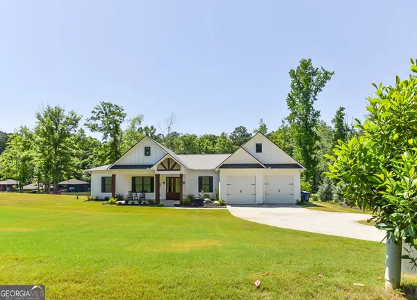 a front view of a house with a garden and deck