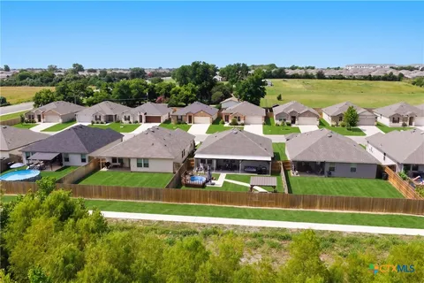 an aerial view of a house with big yard