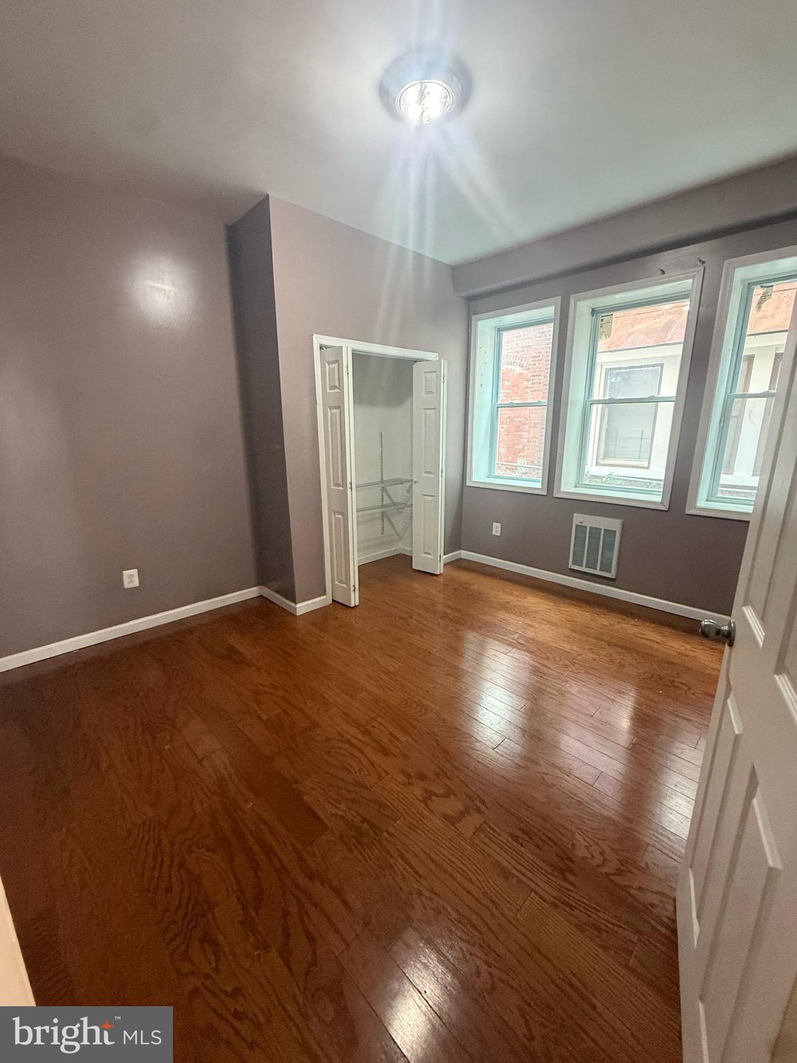 4917 North 12th Street Philadelphia, PA 19141 - Photo 3 of 5 an empty room with wooden floor and windows