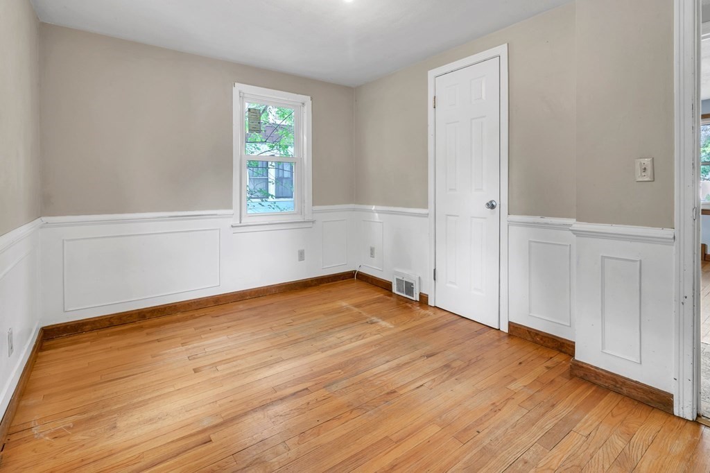 122 Prentice Street Springfield, MA 01104 - Photo 15 of 32 an empty room with wooden floor and windows