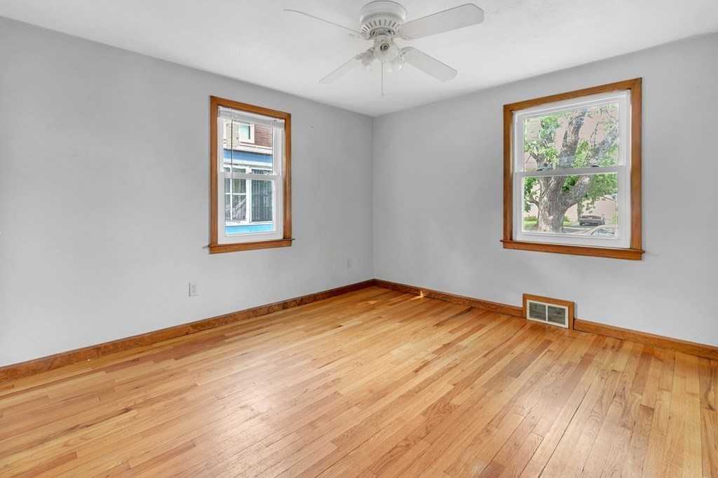 122 Prentice Street Springfield, MA 01104 - Photo 17 of 32 a view of an empty room with wooden floor and a window