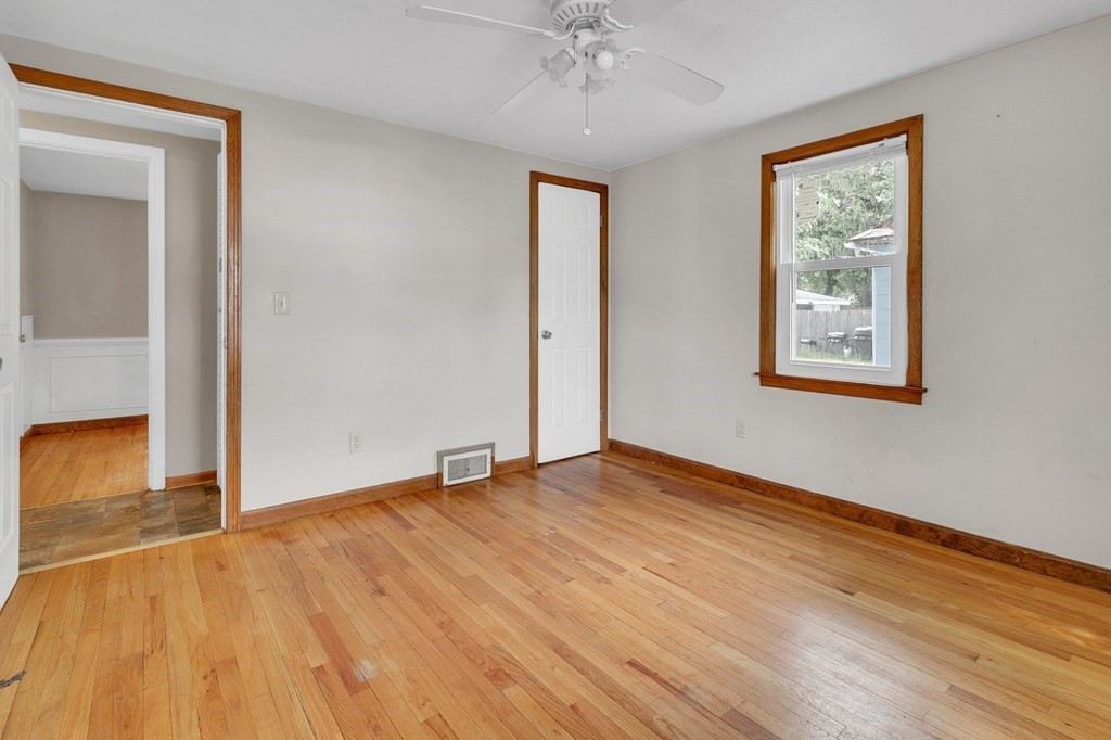 122 Prentice Street Springfield, MA 01104 - Photo 18 of 32 a view of an empty room with wooden floor and a window