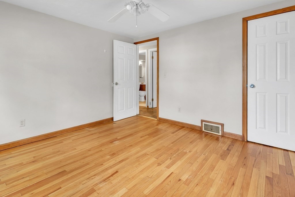 122 Prentice Street Springfield, MA 01104 - Photo 19 of 32 an empty room with wooden floor and way to kitchen