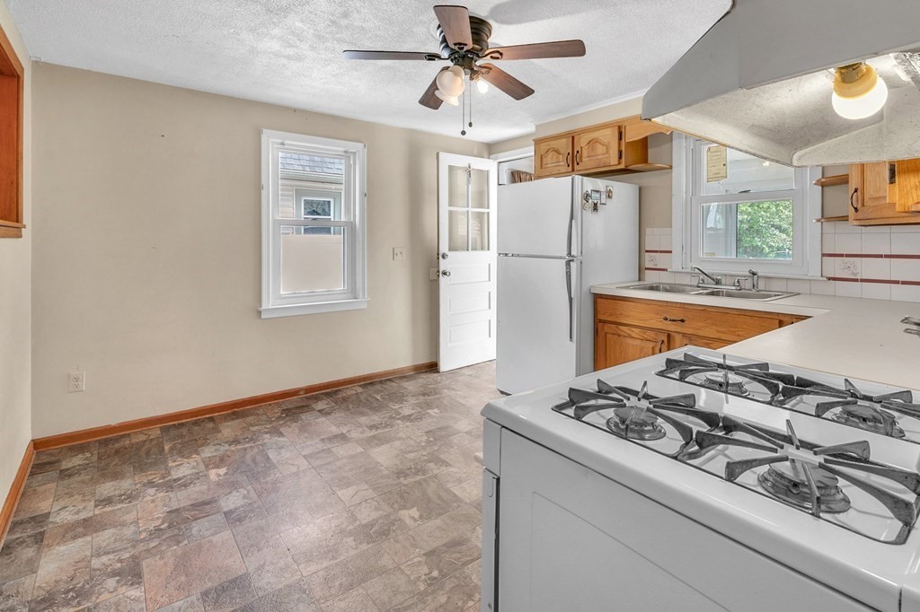122 Prentice Street Springfield, MA 01104 - Photo 4 of 32 a kitchen with stainless steel appliances granite countertop a refrigerator and a stove