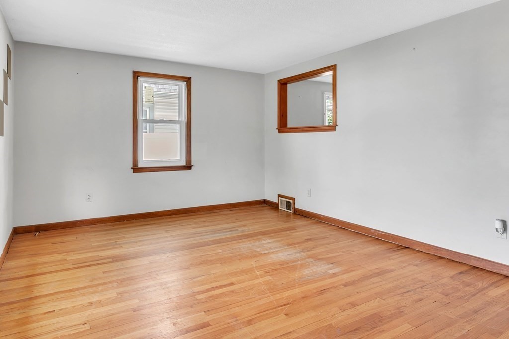122 Prentice Street Springfield, MA 01104 - Photo 7 of 32 a view of an empty room with wooden floor and a window