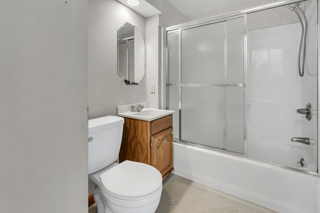 122 Prentice Street Springfield, MA 01104 - Photo 9 of 32 a white toilet sitting next to a bath tub