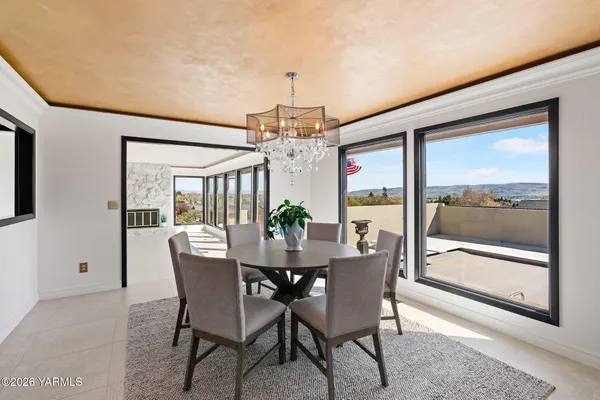 a dining room with furniture a chandelier and wooden floor