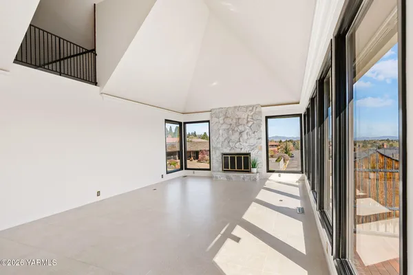 a view of a livingroom with wooden floor and fireplace