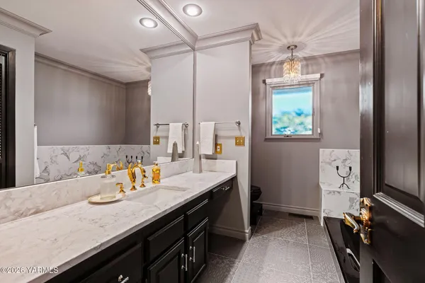 a bathroom with double vanity and a mirror
