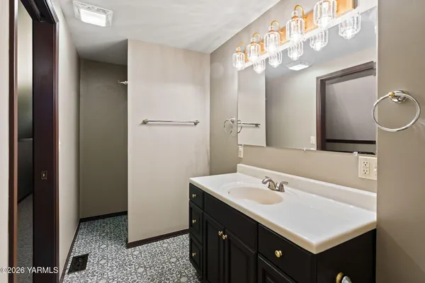 a bathroom with a sink vanity and a mirror
