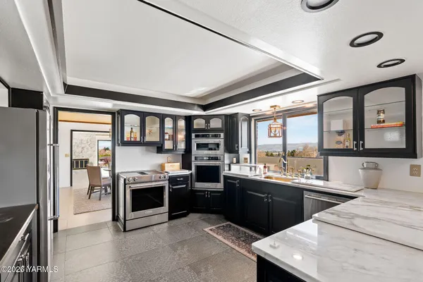 a kitchen with stainless steel appliances granite countertop a stove and a sink