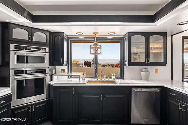 a kitchen with a sink and stainless steel appliances