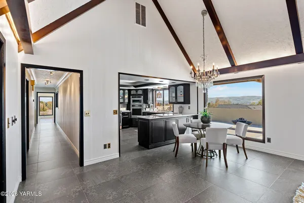 a dining room with furniture and a floor to ceiling window