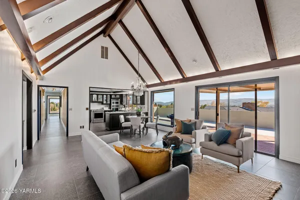 a living room with furniture and a floor to ceiling window