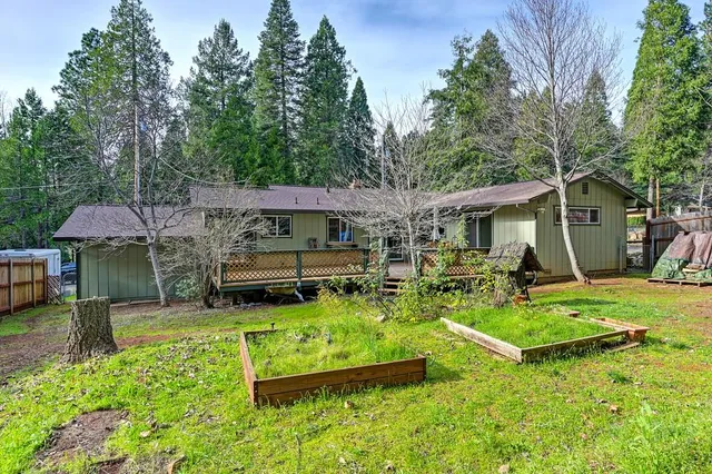 an aerial view of a house with swimming pool garden and patio
