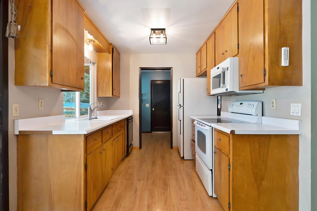 2917 Shadow Lane Pollock Pines, CA 95726 - Photo 7 of 29 a kitchen with stainless steel appliances a sink stove and cabinets