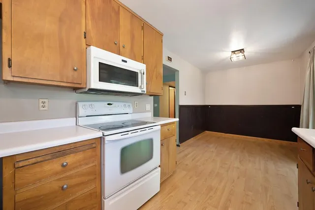 a kitchen with stainless steel appliances a stove microwave and cabinets