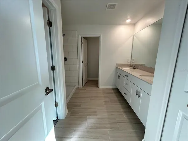 an empty room with a ceiling fan and window