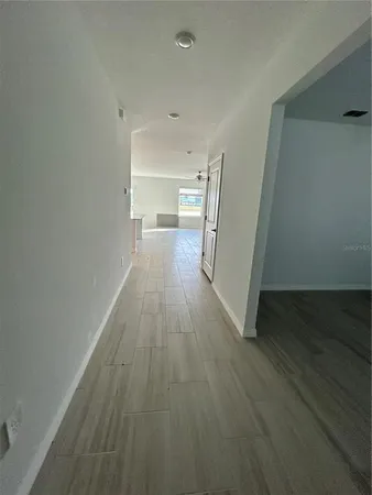 a view of a room with wooden floor and a window
