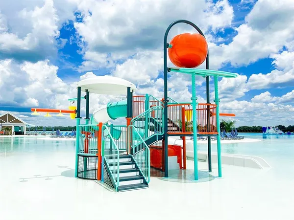 a view of a water with a table and chairs