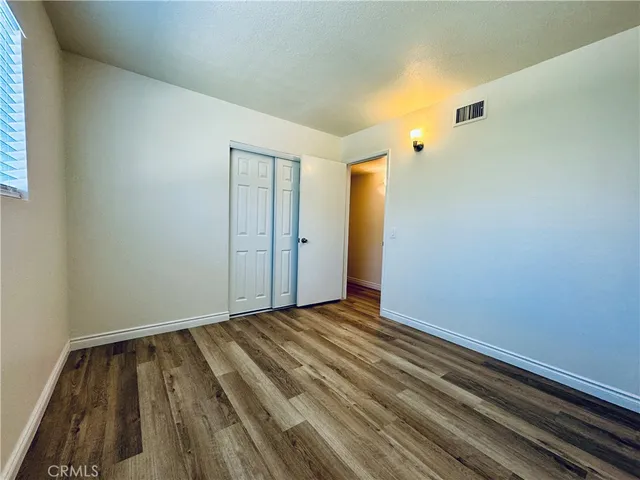 a view of room with wooden floor and window