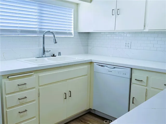 a kitchen with a sink and cabinets