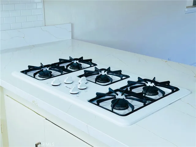 a kitchen with a sink a stove and cabinets
