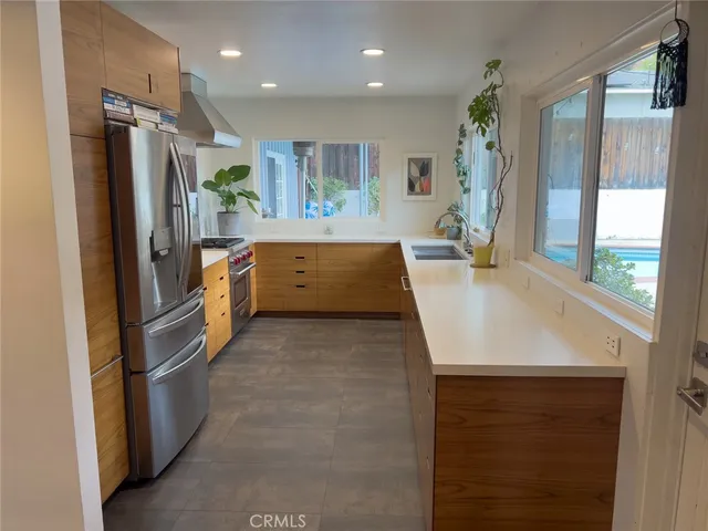 a kitchen with refrigerator and window