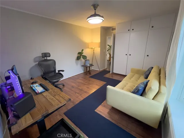 a bedroom with furniture and a wooden floor