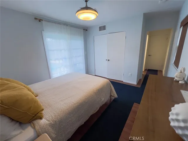 a bedroom with a bed and a mirror