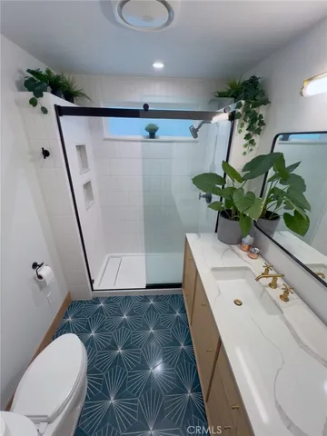 a bathroom with a sink and mirror with bathtub