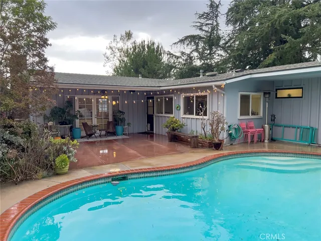 a front view of house with yard and outdoor seating