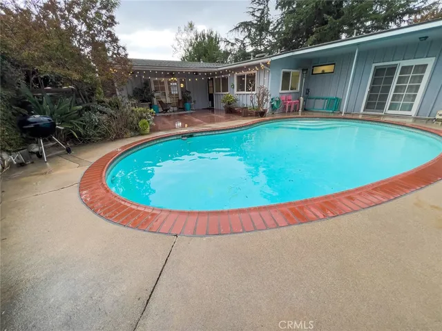 an outdoor space with swimming pool and furniture