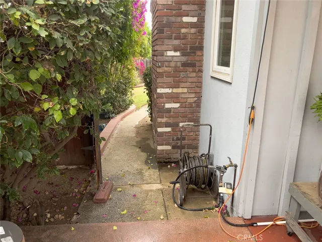 a view of a patio with table and chairs and potted plants
