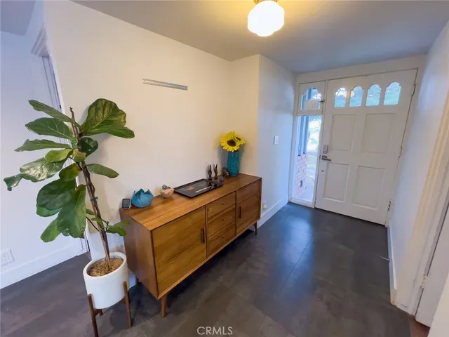a bed room with furniture and a potted plant