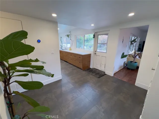 a spacious bedroom with a bed and a large mirror