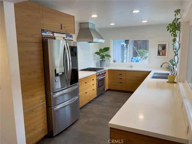a kitchen with stainless steel appliances a refrigerator and a stove