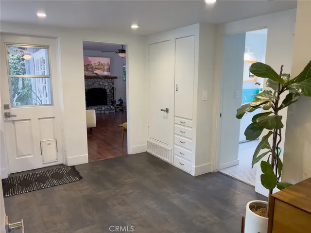 a view of hallway with furniture and a potted plant