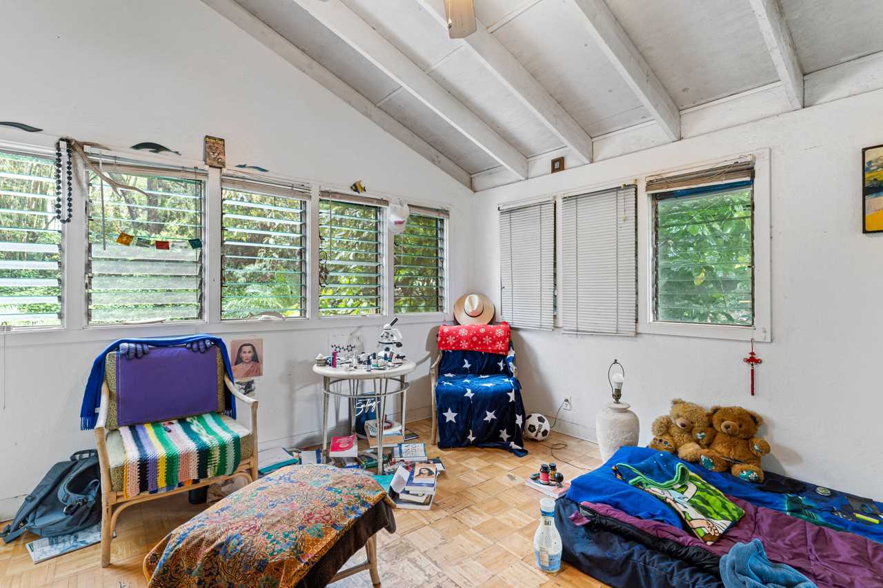 15 Olinda Road Makawao, HI 96768 - Photo 14 of 18 a living room with furniture and a baby crib