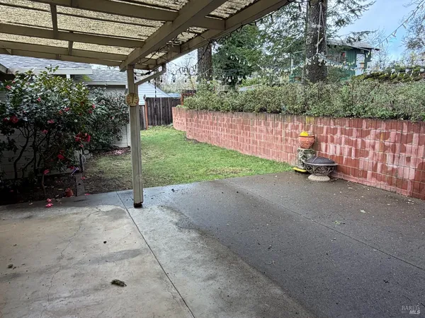 a backyard of a house with a table and chairs
