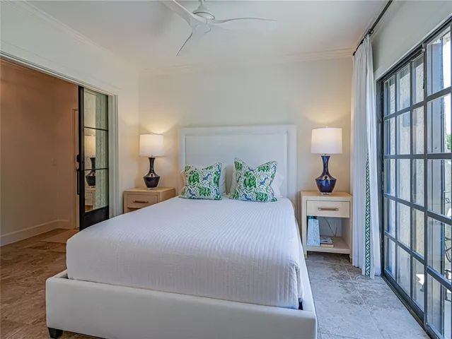 a bedroom with a large bed and a chandelier