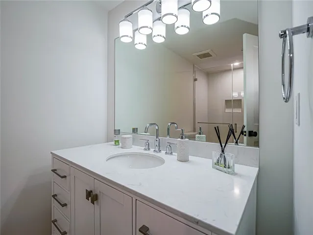 a bathroom with a sink double vanity and a mirror