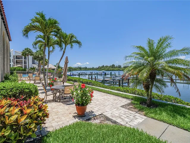 a view of a building with sitting area and potted plants