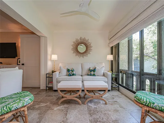 a living room with furniture a rug and a flat screen tv