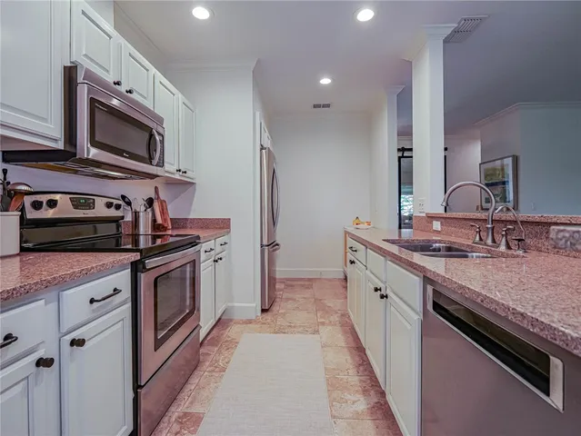 a kitchen with stainless steel appliances granite countertop a sink and a stove
