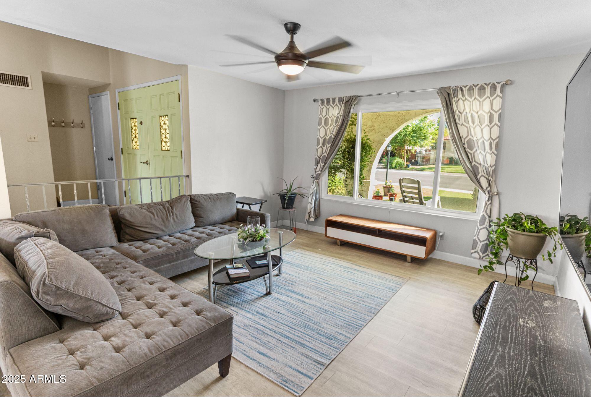 1210 East Harbor View Drive Tempe, AZ 85283 - Photo 11 of 68 a living room with furniture and a large window