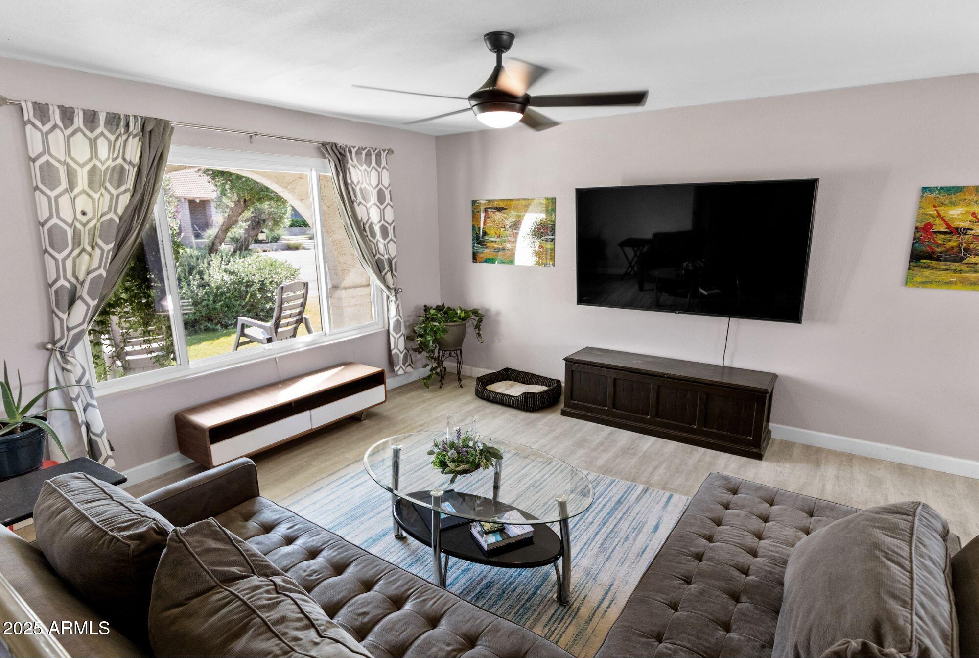 1210 East Harbor View Drive Tempe, AZ 85283 - Photo 12 of 68 a living room with furniture a flat screen tv and a large window